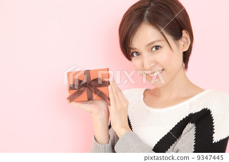 A woman giving a gift 9347445