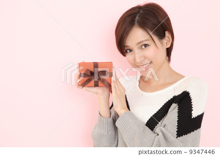 A woman giving a gift 9347446