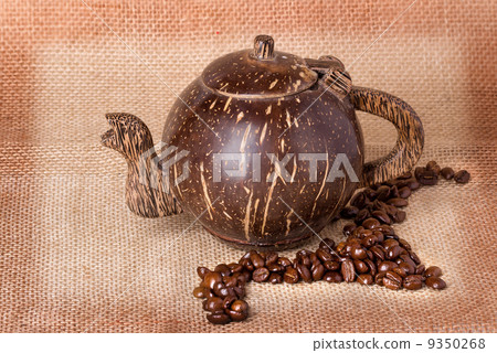 teapot, coffee beans on sackcloth background 9350268