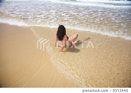 sitting in water at Conil beach 9353448