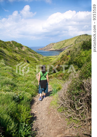 woman hiking towards sea 9353589