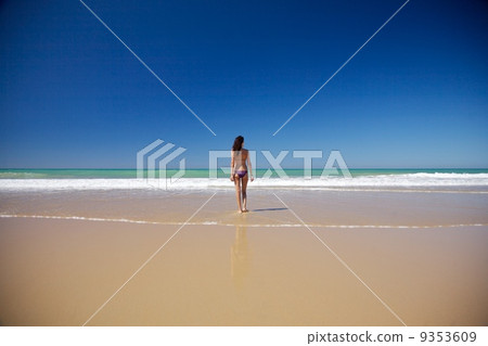 woman walking at seashore in Conil beach 9353609