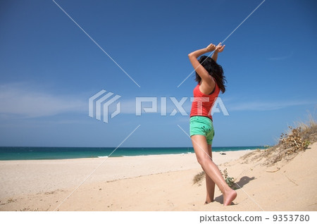 red shirt woman dancing at the beach 9353780