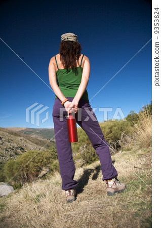 holding red bottle 9353824