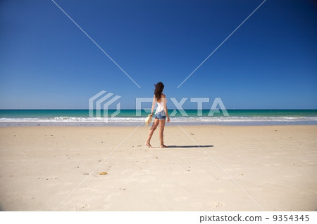 side woman walking at Zahara beach 9354345