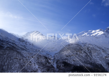 Snowy sunlight mountains, view from ski slope 9356174