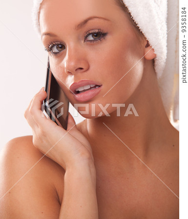 woman after bath using her mobile phone 9358184