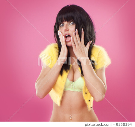 Surprised woman in bra and top 9358394