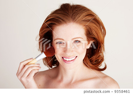 Smiling Woman Applying Blusher Smiling Woman Applying Blusher 9358461