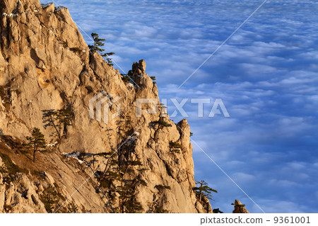 Sunlit cliffs and sea in clouds at evening Sunlit cliffs and sea in clouds at evening 9361001