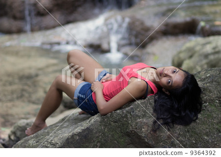 woman lying on a rock woman lying on a rock 9364392