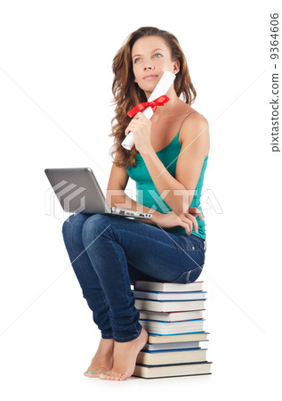 Student with netbook sitting on books Student with netbook sitting on books 9364606