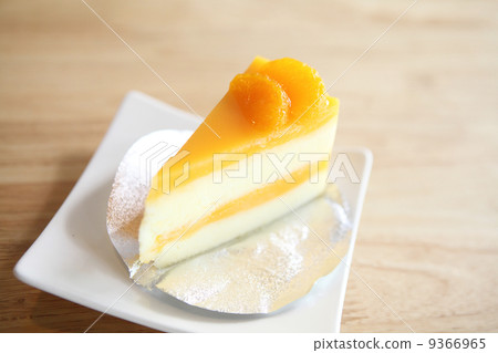 Orange cake on wood background Orange cake on wood background 9366965