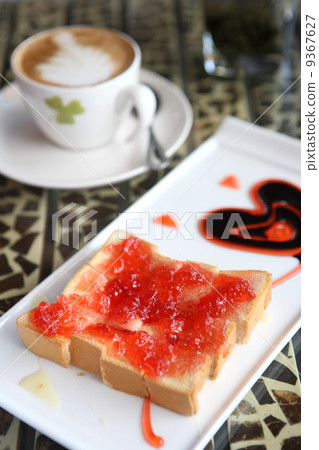 slice of bread with strawberry jam and coffee 9367627