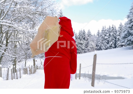 Santa Claus walking along a path Santa Claus walking along a path 9375973