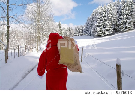 Santa Claus walking along a path 9376018