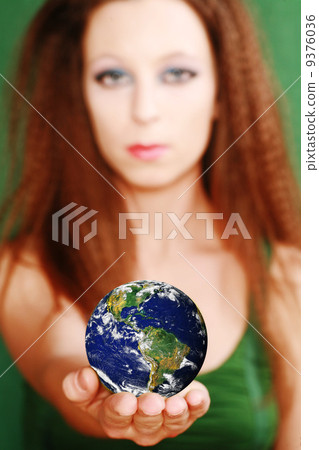 Beauty with globe portrait green concept 9376036