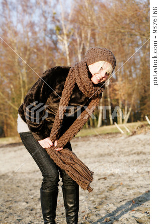 young woman has fun outdoors in autumn scarf young woman has fun outdoors in autumn scarf 9376168