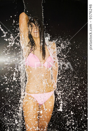 beautiful woman wearing bikini and getting wet because of the water beautiful woman wearing bikini and getting wet because of the water 9376246