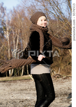 young woman has fun outdoors in autumn scarf young woman has fun outdoors in autumn scarf 9376513