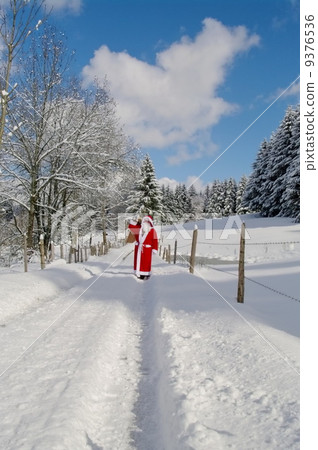 Santa Claus walking along a path 9376536
