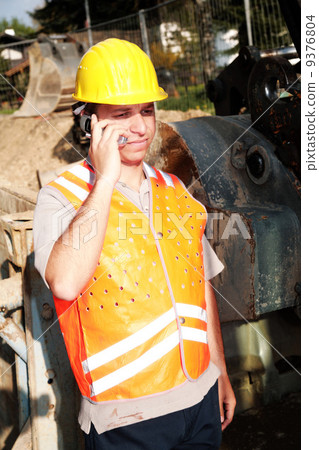 construction worker listening on mobile phone construction worker listening on mobile phone 9376804