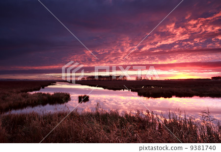 dramatic red fire sunrise over river dramatic red fire sunrise over river 9381740