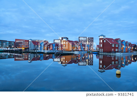 colorful buildings on water at marina Reitdiephaven 9381741