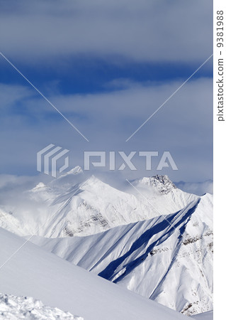 Ski slope and snowy mountains 9381988