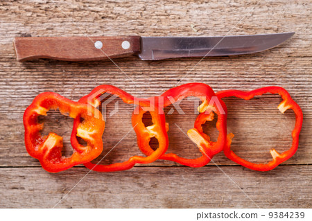sliced red bell peppers and old knife 9384239