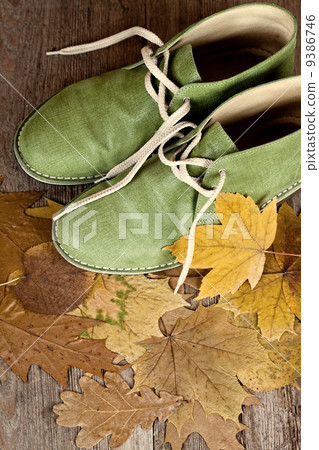 green leather boots and yellow leaves 9386746