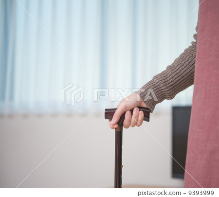 The hands of a woman holding a cane The hands of a woman holding a cane 9393999