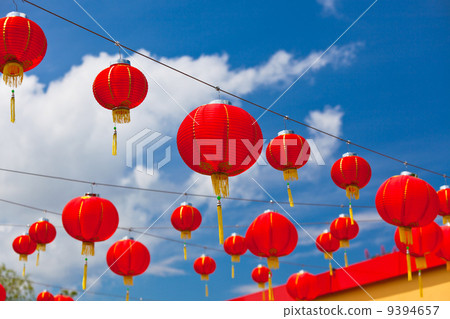 Red Chinese Paper Lanterns against a Blue Sky 9394657