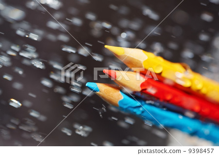 Three color pencils under the rain 9398457