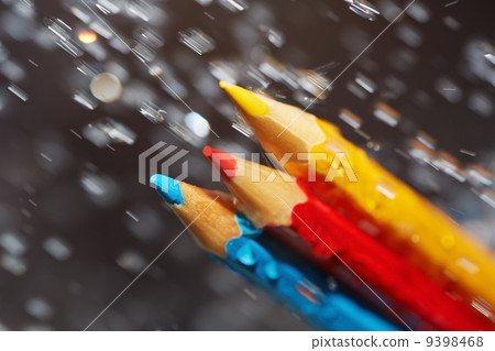 Three color pencils under the rain 9398468
