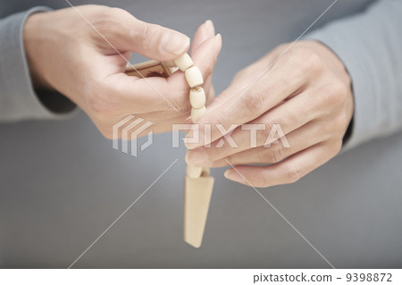 Hands with rosary beads 9398872