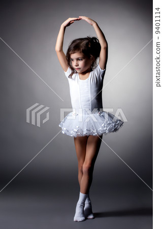 Graceful little gymnast performs in studio 9401114
