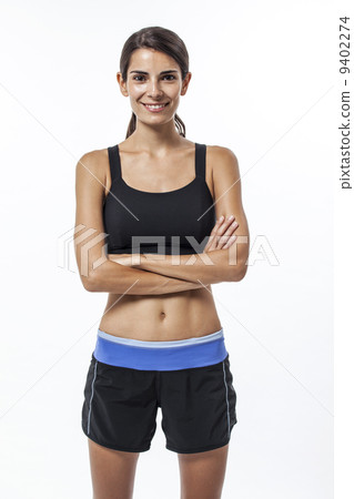 A Caucasian lady in sports attire, arms crossed 9402274