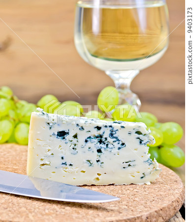 Cheese blue on board with wine and grapes Cheese blue on board with wine and grapes 9403173