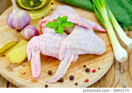 Chicken wings with garlic on a board Chicken wings with garlic on a board 9403174