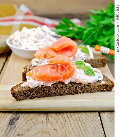 Sandwiches on bread with salmon on board Sandwiches on bread with salmon on board 9403633