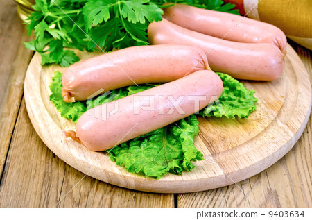 Sausages on board with parsley and napkin 9403634