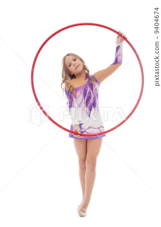 Smiling artistic gymnast posing with red hoop Smiling artistic gymnast posing with red hoop 9404674