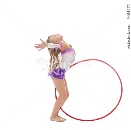 Flexible gymnast dancing with hoop in studio 9404675