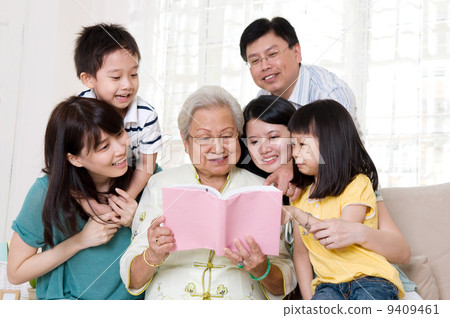 Asian family reading book at home 9409461