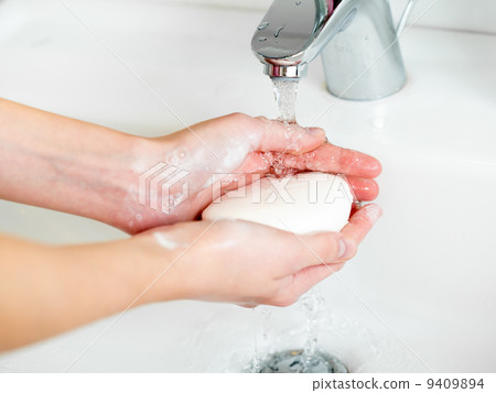 Washing of hands with soap in bathroom close up Washing of hands with soap in bathroom close up 9409894