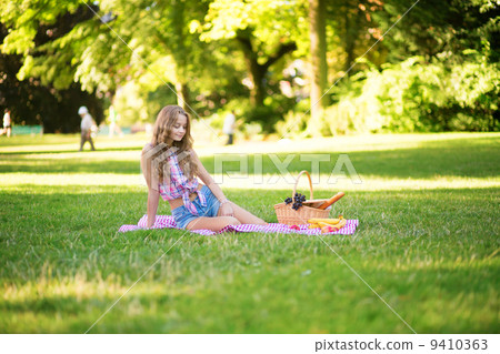 Girl having a picnic in park Girl having a picnic in park 9410363