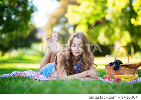 Beautiful girl on a picnic in park Beautiful girl on a picnic in park 9410364
