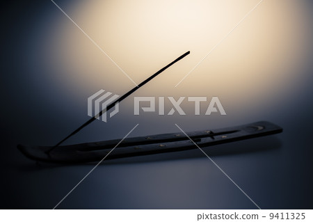 Incense stick on a wooden support on a white background 9411325