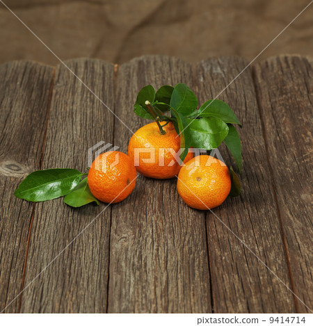 Fresh tangerines with leaves on a wooden table. 9414714